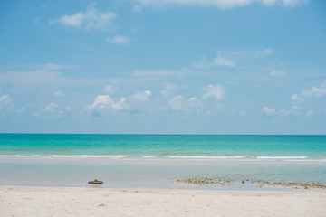 Fototapeta na wymiar Beach with white sand and blue skies