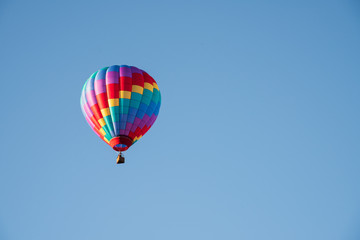 Hot Air Balloon Soaring Up in a Cloudless Blue Sky