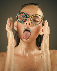 fashion portrait. Makeup of sugar candy kiss on lips. Beauty and fashion model of glamour girl. Sprinkles lipstick and glasses on girl, valentines day