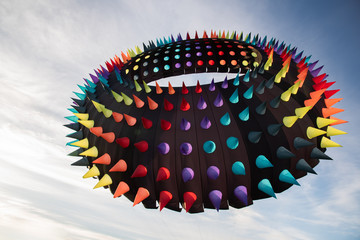 Giant, Ring-Shaped Rainbow Spike Kite Flying in the Sky