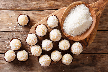Brazilian Coconut Kisses (Beijinhos de Coco) condensed milk and coconut flakes close-up. Horizontal top view