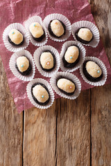 Authentic Brazilian sweet candies Olho de sogra with dried plums close-up. Vertical top view