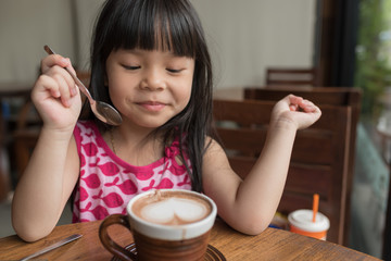  Adorable little girl drinking hot chocolate