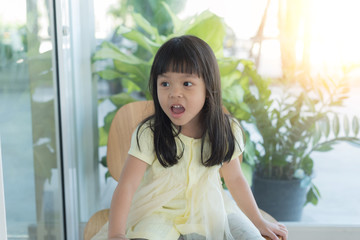 lovely little girl sitting at the garden in summer day