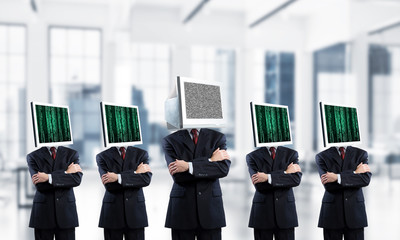 Businessmen with monitors instead of head.