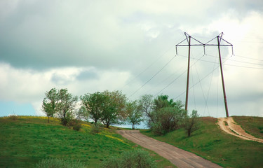 High-voltage transmission lines in the summer landscape, color photo,