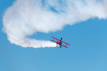 Fototapeta na wymiar Biplane Smoke with Wingwalker