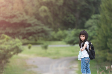 explorer kid girl walking with backpack hiking