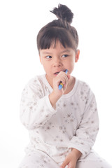Little girl brushing her teeth isolated on white background