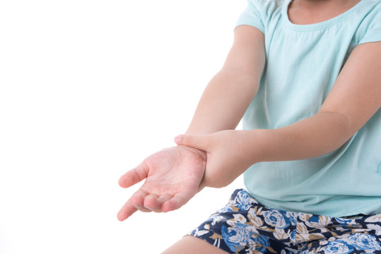 Close up woman's hand holding children's elbow. Elbow pain concept.