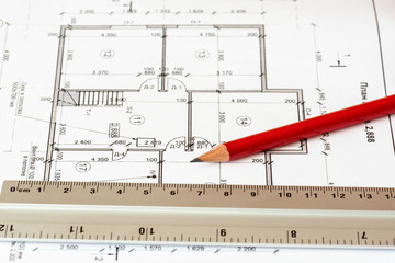 The architectural plan of the house is printed on a white sheet of paper. A red pencil and a ruler on it. June 2018, Russia, Moscow