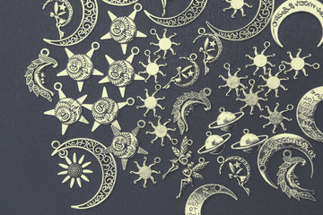 Charm pendants for crafting. Sun and moon symbols. Star and planet figures.