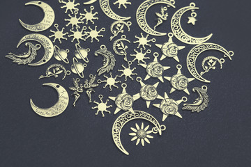 Charm pendants for crafting. Sun and moon symbols. Star and planet figures.