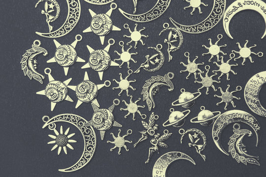 Charm pendants for crafting. Sun and moon symbols. Star and planet figures.
