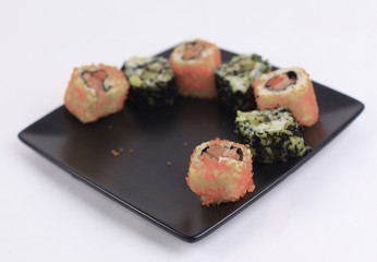 set of Sushi rolls on black plate
