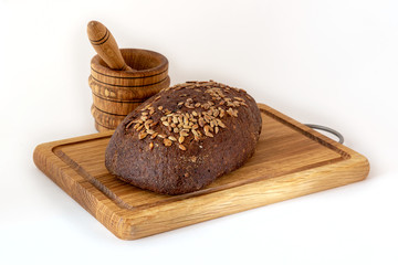Loaf of black bread with seeds