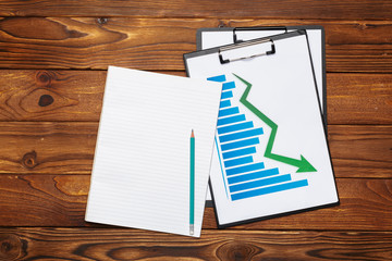 Top view of business paper chart or graph on wooden table