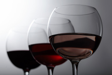 Glasses of  pink , red and white wine .