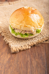 tuna burger on wood background.