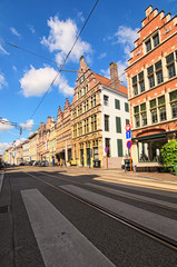 Fototapeta na wymiar Ghent, Belgium? May 03, 2018: Historical street with buildings in typical Flemish architecture, painted with vivid colors. Spring morning view. Selective focus with wide angle lens