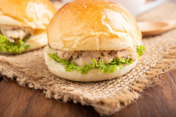 tuna burger and coffee on wood background.