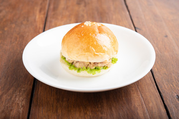 tuna burger and coffee on wood background.
