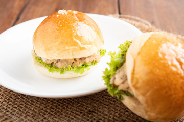 tuna burger and coffee on wood background.