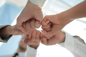 Close up .businessman and businesswoman making a fist bump on building background