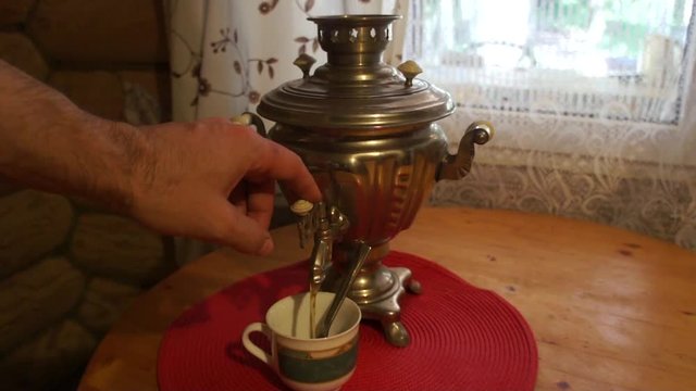 Man Pouring Tea From Russian Kettle "samovar"