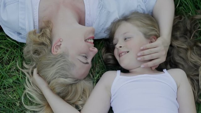 Mommy and her little child want to be closer, stare trustfully at relative eyes.
