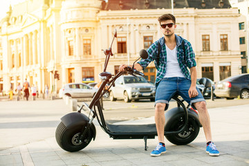 young man sitting on  electric vehicle