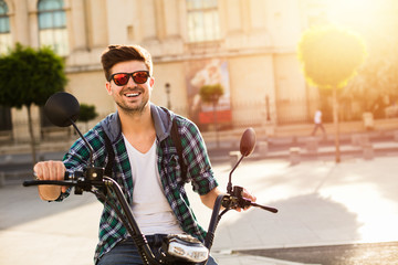 Naklejka premium young man sitting on electric vehicle