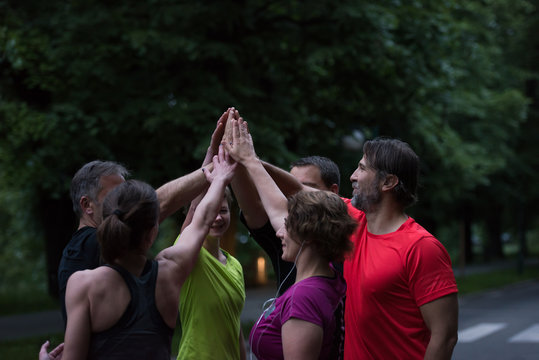 Runners Giving High Five To Each Other