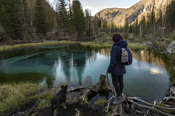 Woman standing next to geyser