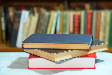Book, stack of hardback books on table. Top view.