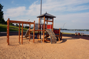 Childrens playground on lake coast in summer