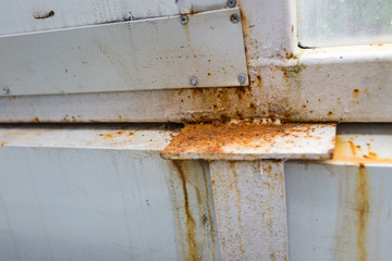 Old iron window with corrosion of metal from the rain
