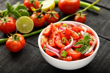 Fresh tomato salad topped with herbs 