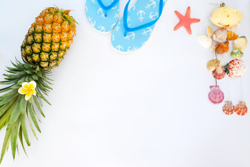 Summer vacation background concept. Pineapple, slippers, starfish and seashells. Creative flat lay, top view design