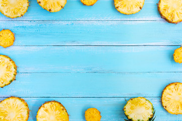 Tropical pineapple on wood plank blue color. frame layout summer vacation background concept.