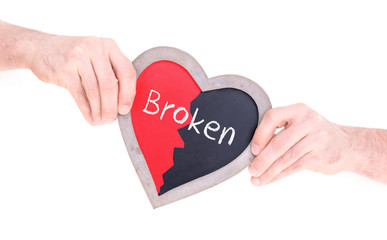 Adult holding heart shaped chalkboard - Broken