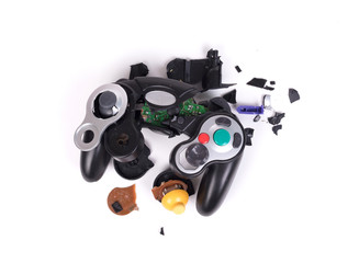 Broken video game controller on white background