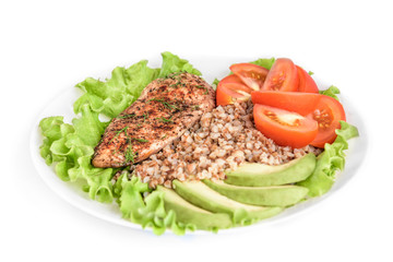 Grilled chicken breast with buckwheat porridge, tomatoes and avocado isolated on white background.