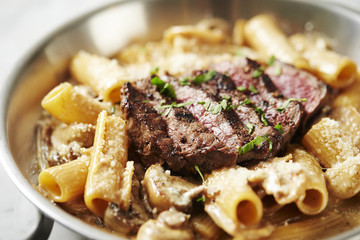 Beef steak with penne pasta 
