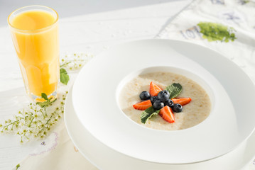 Oatmeal with berries and orange juice