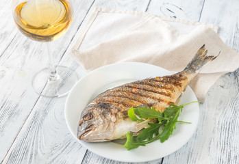 Grilled gilt-head bream on the plate