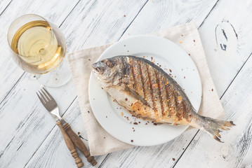 Grilled gilt-head bream on the plate
