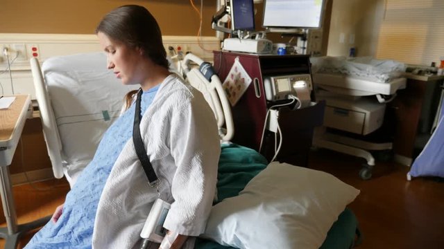 A handheld shot of a woman in a hospital bed during natural labor