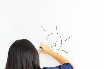 business, people, idea, startup and education concept - close up of hand with marker drawing light...