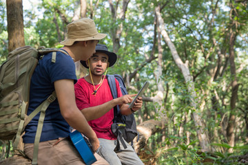 two male hiker using tablet pc